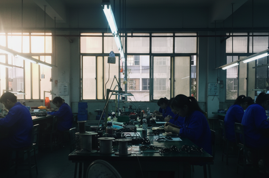 A product manager analyzing product samples from different regions under a bright light