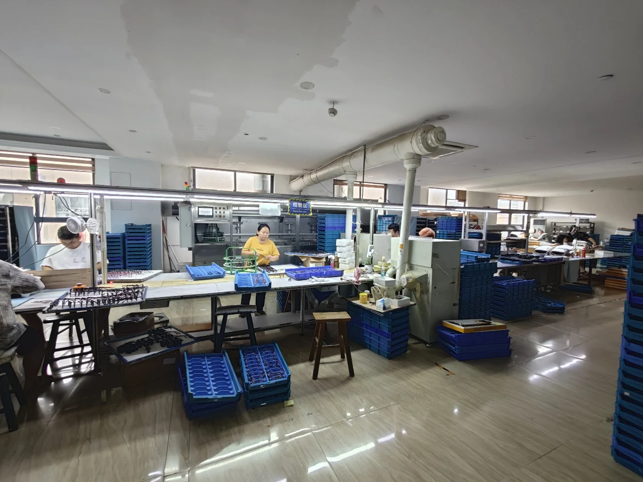 Organized mass production line for efficient assembly and quality monitoring of glasses.